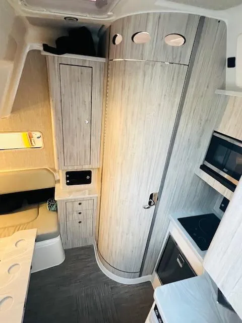 Slide: The Image of 2024 Regulator 41 boat interior with modern kitchen and storage cabinets. - 17