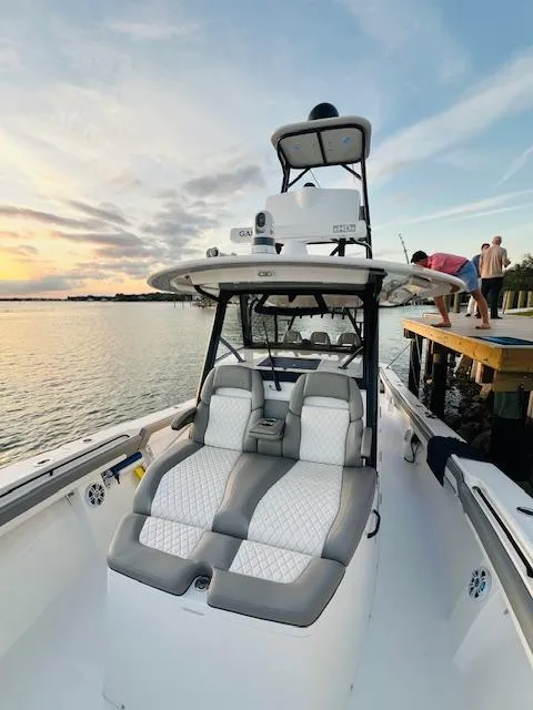 Slide: The Image of 2024 Regulator 41 boat docked at sunset with plush seating. - 19