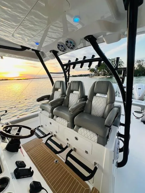 Slide: The Image of 2024 Regulator 41 boat interior with luxury seating at sunset. - 22