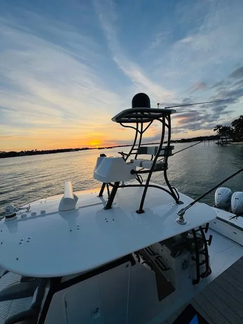 Slide: The Image of 2024 Regulator 41 boat at sunset on a serene lake. - 29