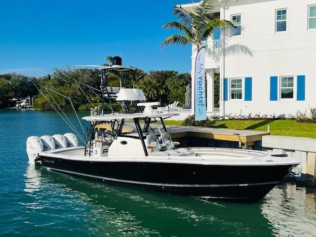 Slide: The Image of 2024 Regulator 41 boat docked near a waterfront property. - 3