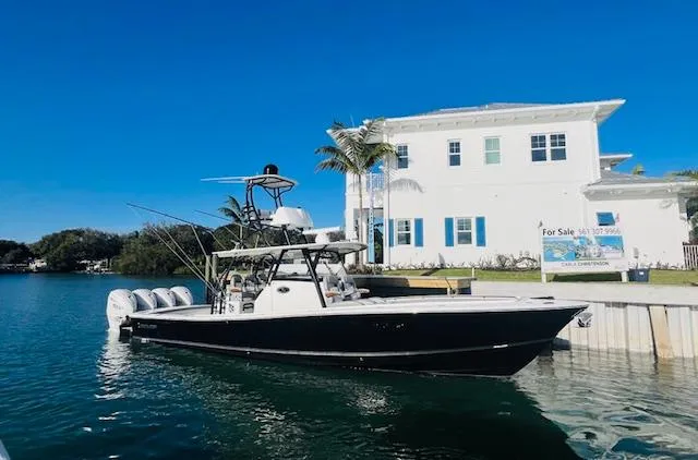 Slide: The Image of 2024 Regulator 41 boat docked near waterfront property on a sunny day. - 4