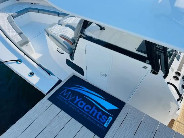 Slide: The Image of 2024 Regulator 41 yacht docked, showcasing spacious seating and sleek design. - 5