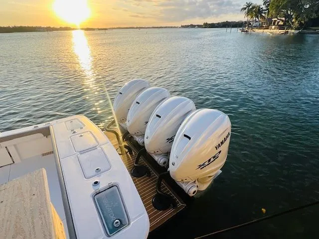 Slide: The Image of 2024 Regulator 41 boat with Yamaha engines at sunset on the water. - 7
