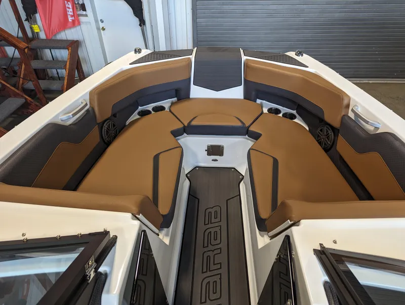 Slide: The Image of 2024 Scarab 235 ID boat interior with brown and black seating. - 2