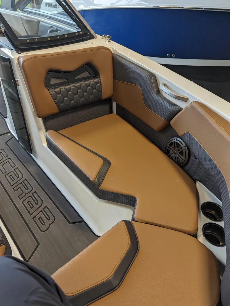 Slide: The Image of 2024 Scarab 235 ID boat interior with tan and black seating. - 3