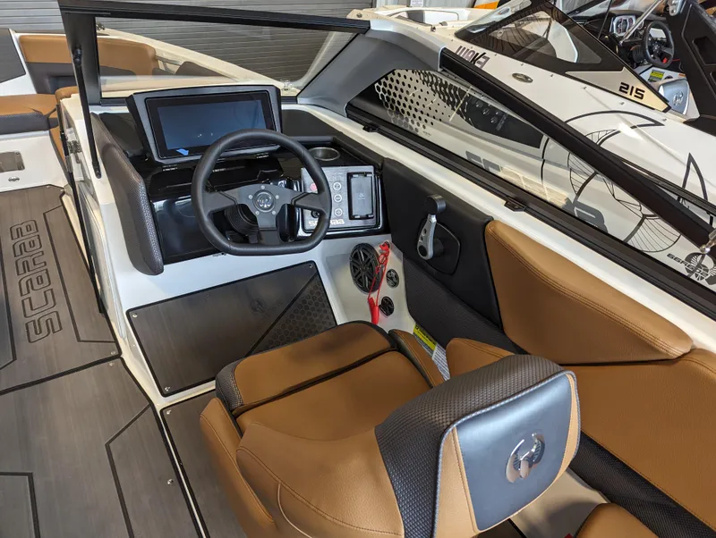 Slide: The Image of 2024 Scarab 235 ID boat interior with modern dashboard and brown leather seats. - 5