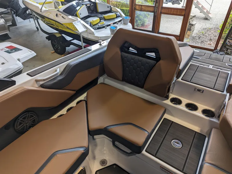 Slide: The Image of 2024 Scarab 235 ID boat interior with brown and black seating. - 8