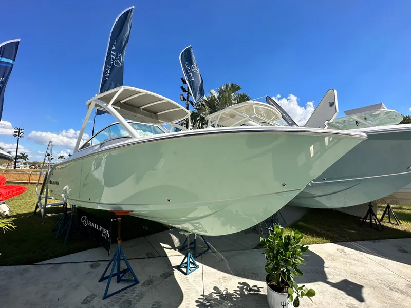 The Image of 2024 Sailfish 226 DC boat displayed outdoors under a clear blue sky. - 0