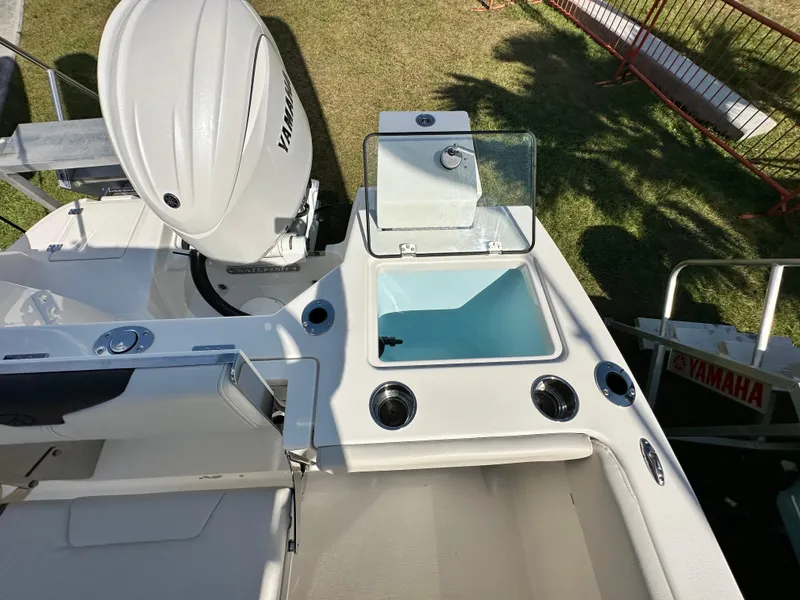 Slide: The Image of 2024 Sailfish 226 DC boat with Yamaha engine, featuring a livewell and seating area. - 13