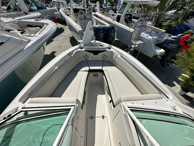 Slide: The Image of 2024 Sailfish 226 DC boat interior with seating and speakers, displayed at a boat show. - 15