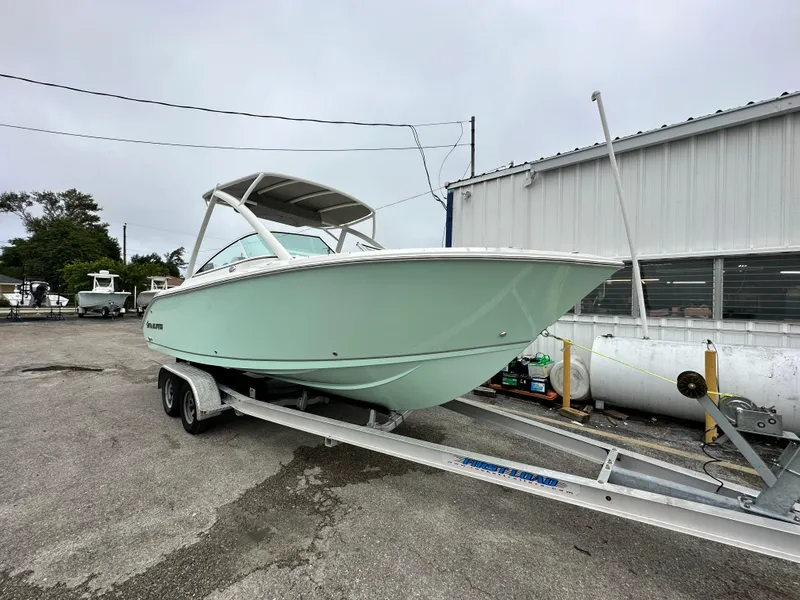 Slide: The Image of 2024 Sailfish 226 DC boat on a trailer outside a warehouse. - 17