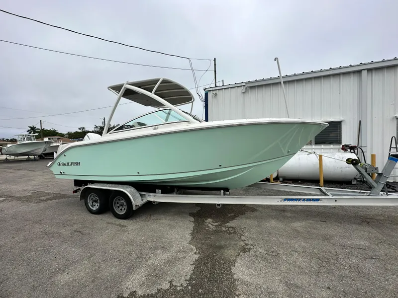 Slide: The Image of 2024 Sailfish 226 DC boat on a trailer in a marina. - 18