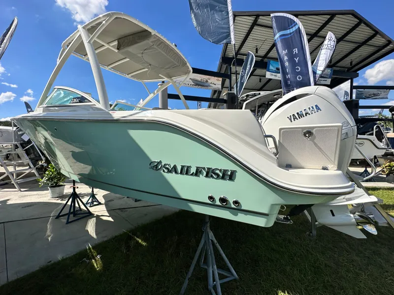 Slide: The Image of 2024 Sailfish 226 DC boat displayed outdoors with Yamaha engine. - 2