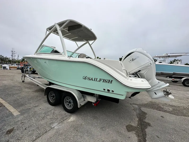 Slide: The Image of 2024 Sailfish 226 DC boat on a trailer in a parking lot. - 22