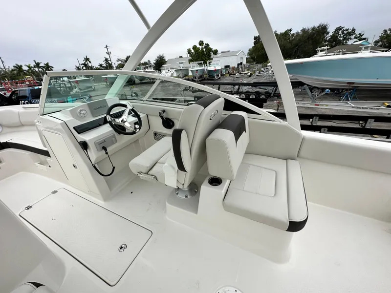 Slide: The Image of 2024 Sailfish 226 DC boat interior with helm and seating. - 24