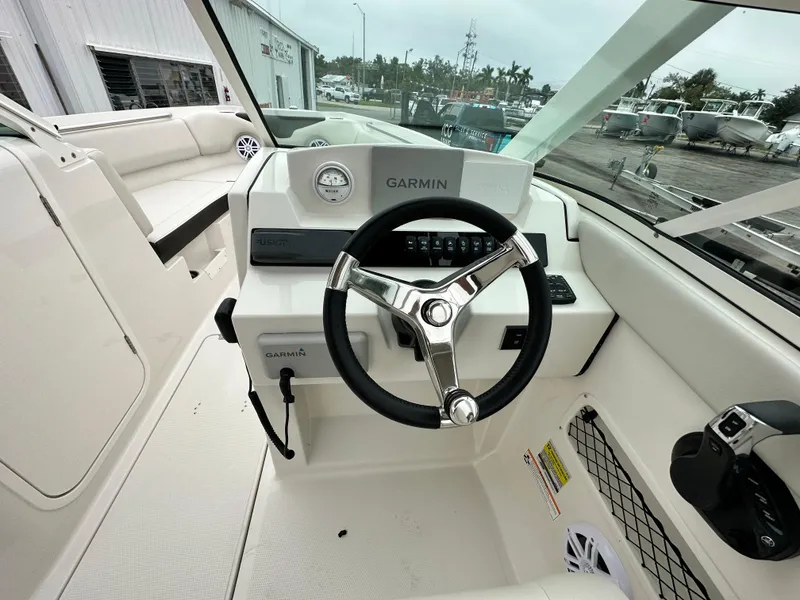 Slide: The Image of 2024 Sailfish 226 DC boat cockpit with Garmin navigation system. - 25