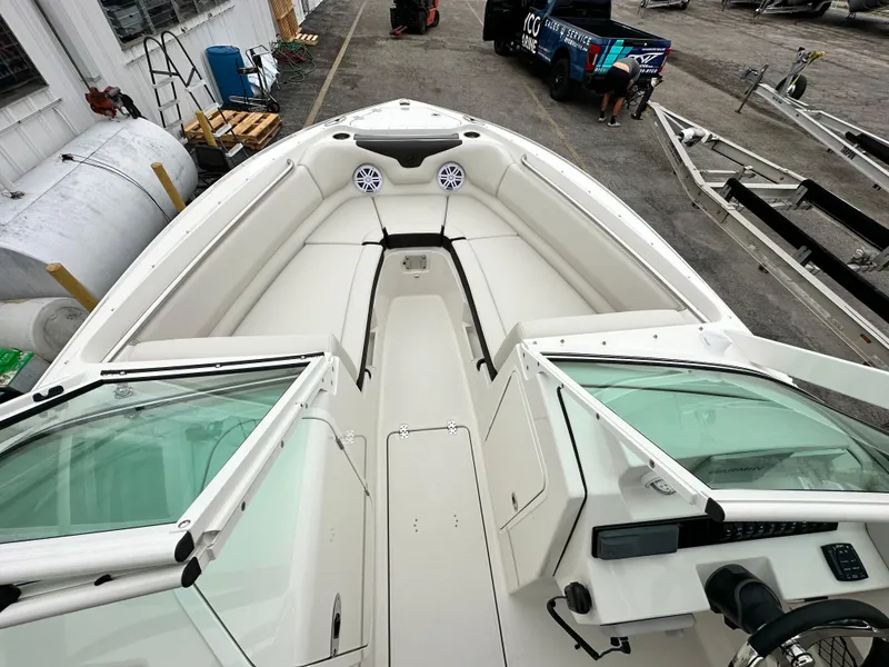 Slide: The Image of 2024 Sailfish 226 DC boat interior with open bow seating and dashboard view. - 26