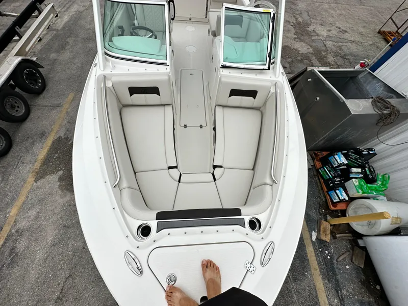 Slide: The Image of 2024 Sailfish 226 DC boat interior with white cushioned seating. - 28