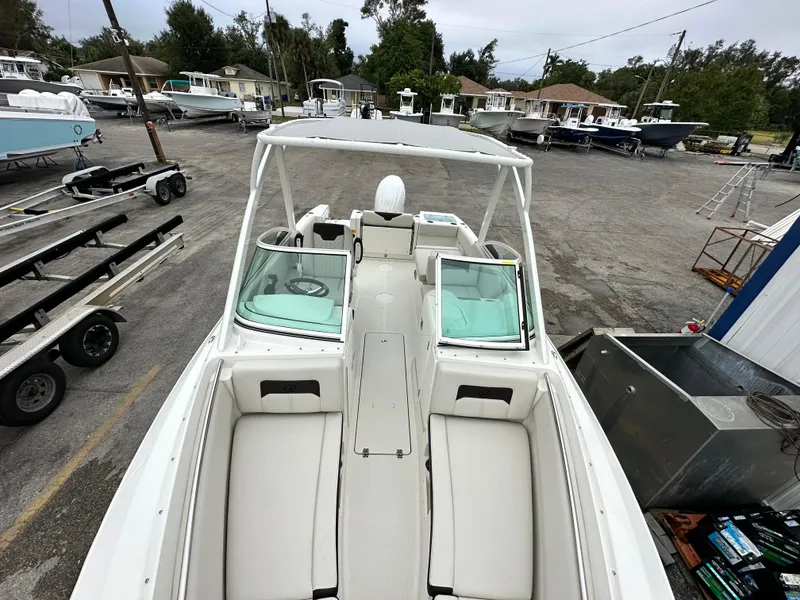 Slide: The Image of 2024 Sailfish 226 DC boat with white interior, docked at a marina. - 29