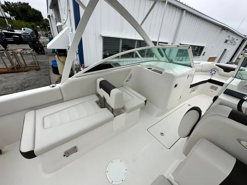 Slide: The Image of 2024 Sailfish 226 DC boat interior with white seating and windshield. - 32