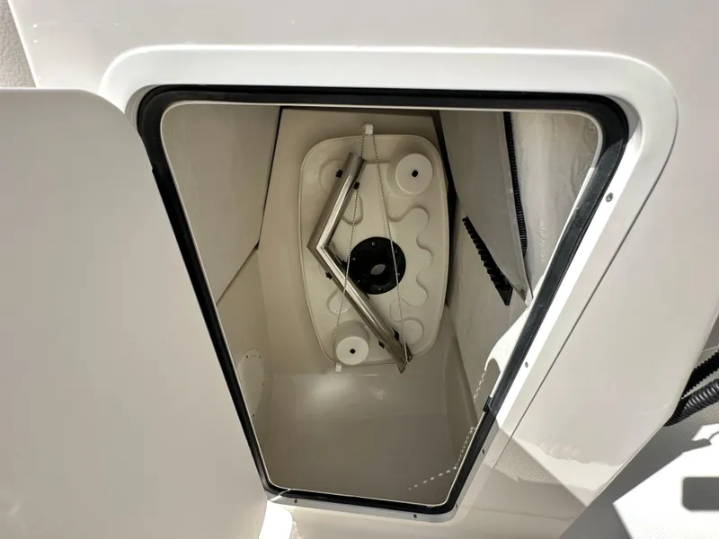 Slide: The Image of 2024 Sailfish 226 DC storage compartment with hatch open, showcasing interior design. - 35