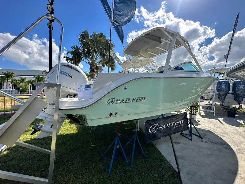 Slide: The Image of 2024 Sailfish 226 DC boat displayed outdoors with Yamaha engine, under a sunny sky. - 6