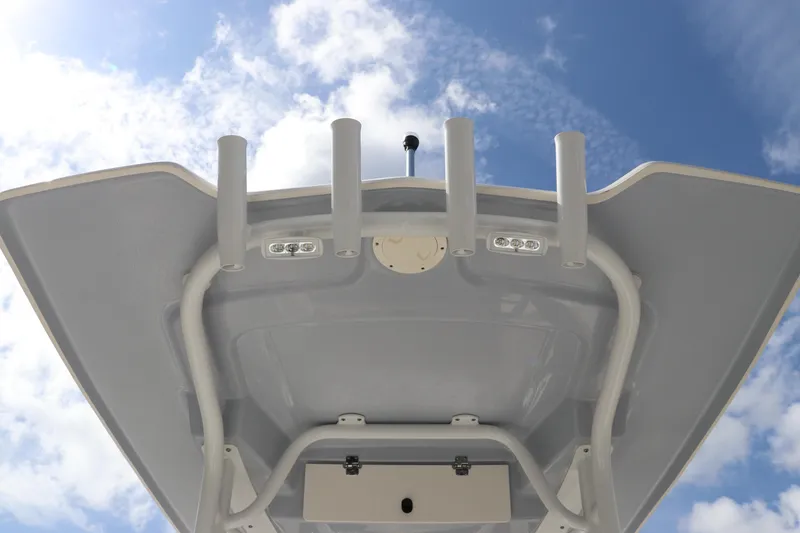 Slide: The Image of 2024 Robalo 226 Cayman boat T-top against blue sky. - 14