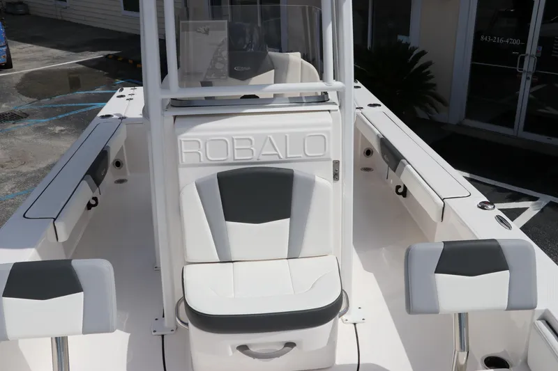 Slide: The Image of 2024 Robalo 226 Cayman boat interior with white and gray seating. - 18