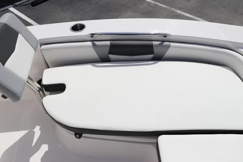 Slide: The Image of 2024 Robalo 226 Cayman boat seating area with white cushioned seats. - 22