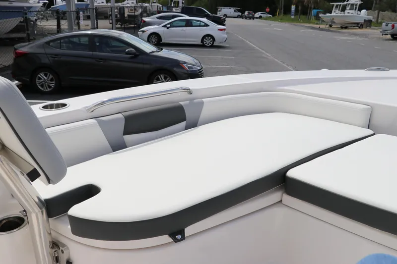 Slide: The Image of 2024 Robalo 226 Cayman boat interior with cushioned seating. - 23