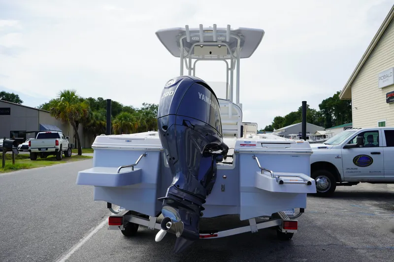 Slide: The Image of 2024 Robalo 226 Cayman boat with Yamaha engine, parked outdoors on a trailer. - 4