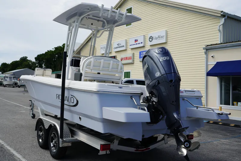 Slide: The Image of 2024 Robalo 226 Cayman boat with Yamaha 200 engine on trailer, parked outside dealership. - 5