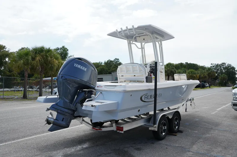 Slide: The Image of 2024 Robalo 226 Cayman boat with Yamaha engine on trailer, parked outdoors. - 6