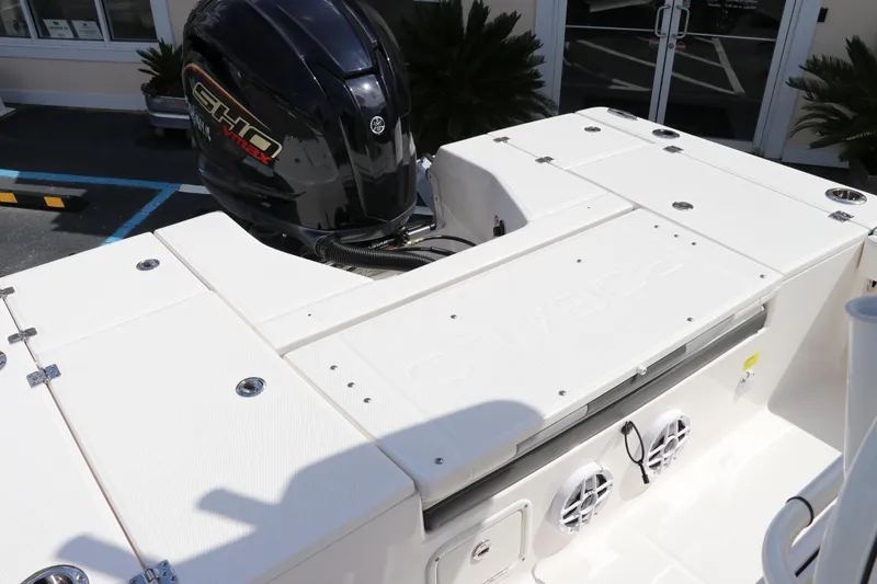 Slide: The Image of 2024 Robalo 226 Cayman boat with outboard motor and rear deck. - 7