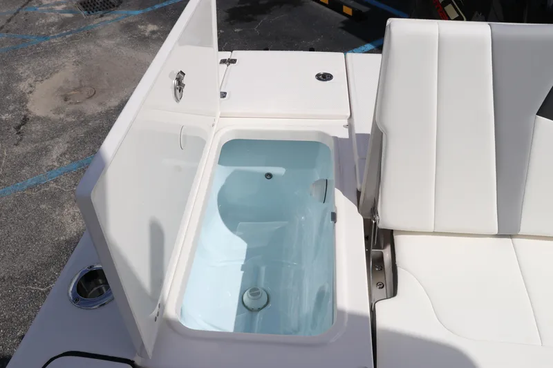 Slide: The Image of 2024 Robalo 226 Cayman boat with open storage compartment and seating. - 9