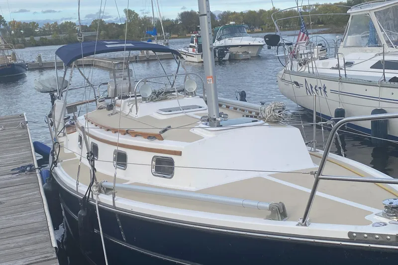 Slide: The Image of Com-Pac 27 sailboat, 2014 model, docked at a marina with other boats. - 0