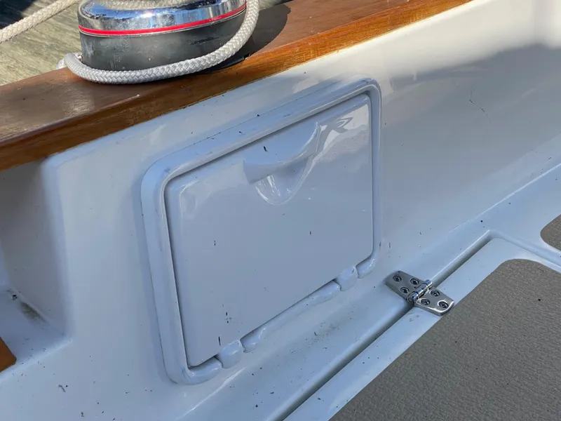 Slide: The Image of Close-up of a 2014 Com-Pac 27 sailboat's deck storage compartment. - 14