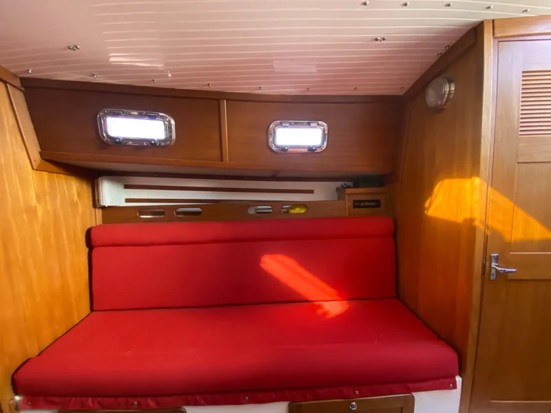 Slide: The Image of Interior cabin of 2014 Com-Pac 27 sailboat with red cushioned seating. - 20