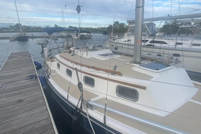 Slide: The Image of 2014 Com-Pac 27 sailboat docked at a marina. - 4