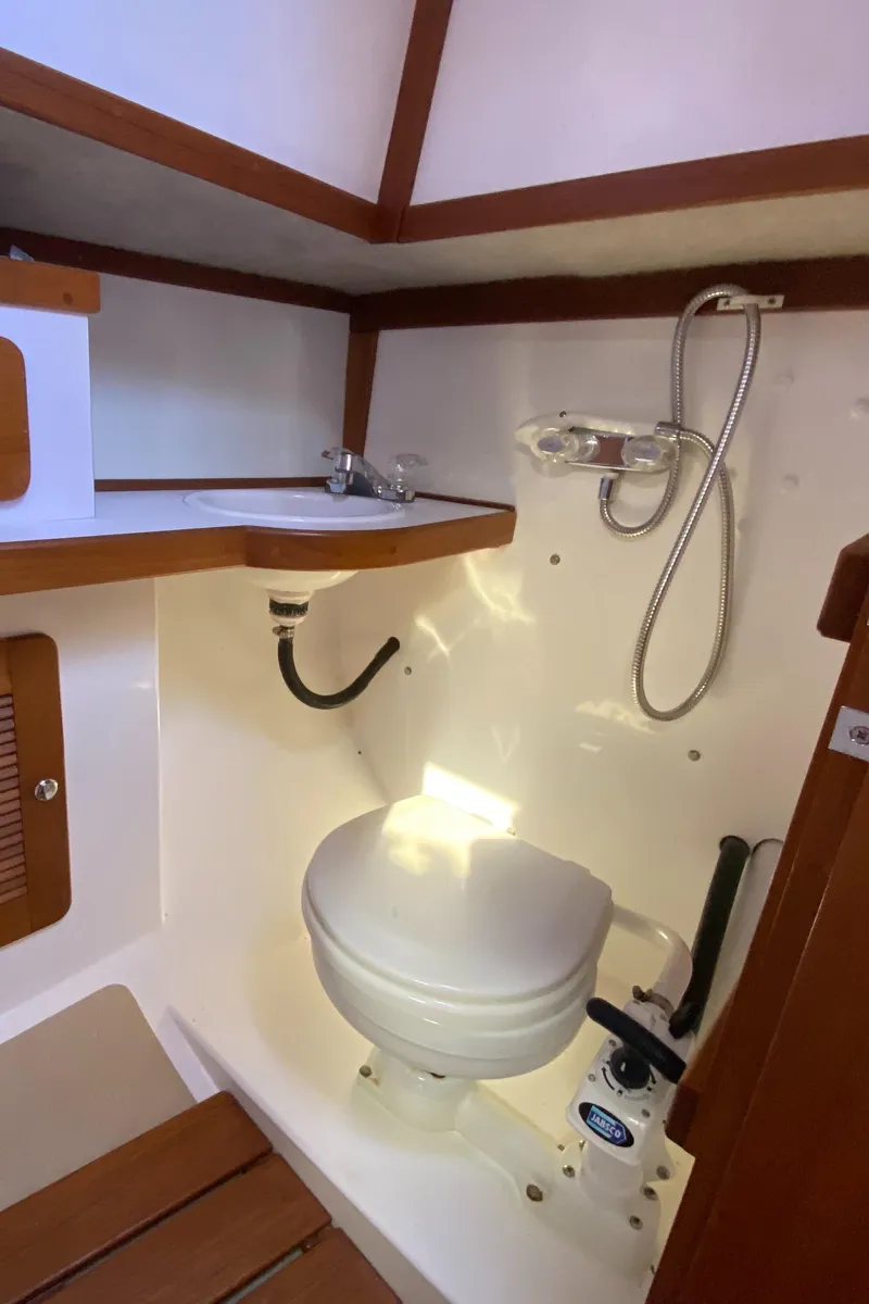 Slide: The Image of 2014 Com-Pac 27 sailboat bathroom with toilet and shower. - 42
