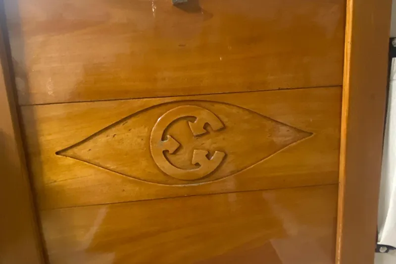 Slide: The Image of Wooden interior detail of a 2014 Com-Pac 27 sailboat with carved emblem. - 8