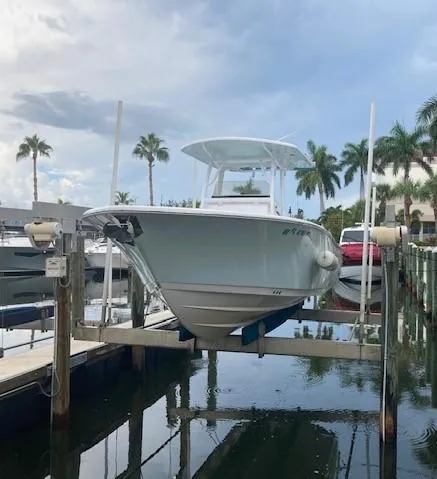 Slide: The Image of 2014 Sportsman Heritage 251 Center Console boat docked at marina. - 10