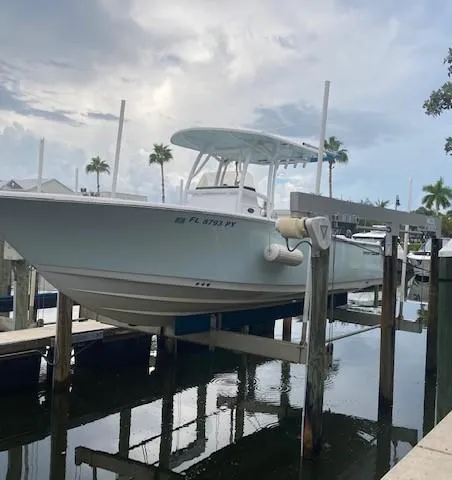 Slide: The Image of 2014 Sportsman Heritage 251 Center Console boat docked at marina. - 11