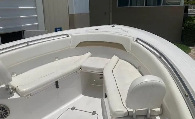 Slide: The Image of 2014 Sportsman Heritage 251 Center Console boat with white cushioned seating. - 5