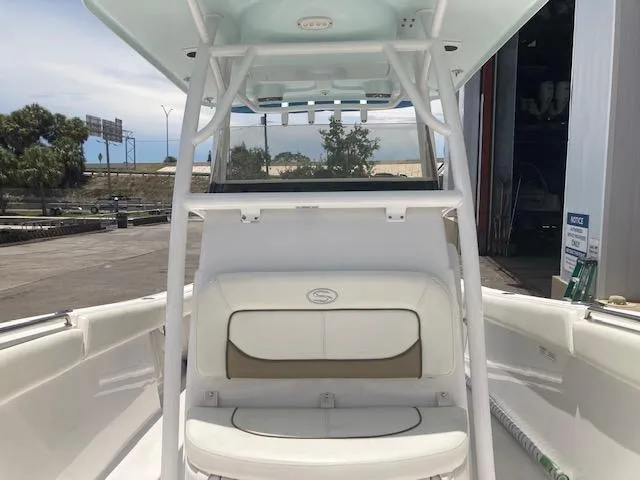 Slide: The Image of 2014 Sportsman Heritage 251 Center Console boat interior with seating and console. - 6