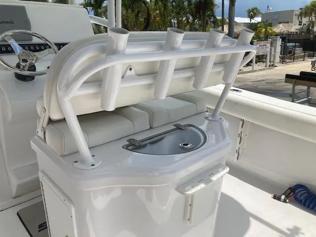 Slide: The Image of 2014 Sportsman Heritage 251 Center Console boat with rod holders and seating. - 7