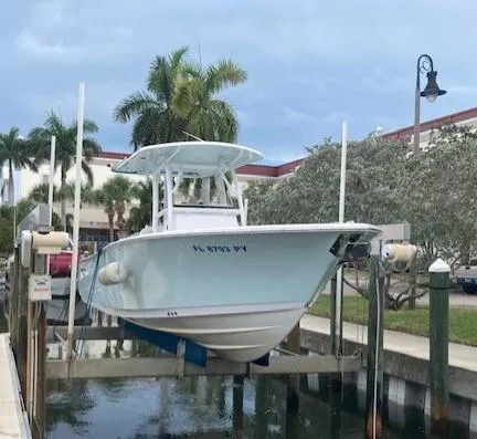 Slide: The Image of 2014 Sportsman Heritage 251 Center Console boat docked on a lift. - 9