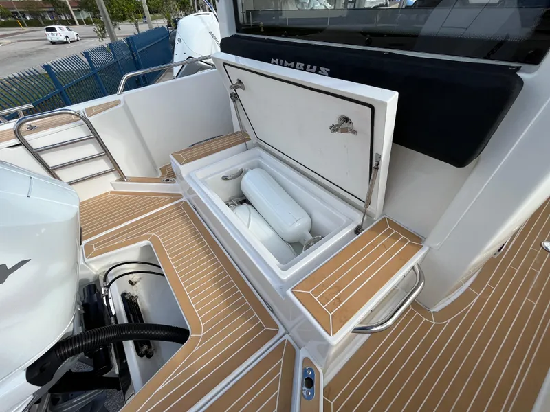 Slide: The Image of 2024 Nimbus Commuter 9 #136 boat with open storage compartment. - 11