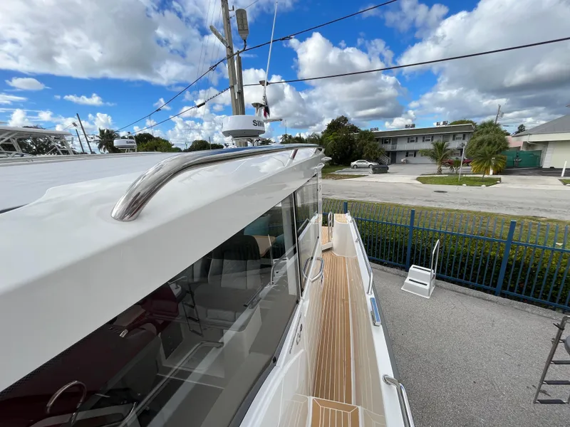 Slide: The Image of 2024 Nimbus Commuter 9 #136 boat exterior with wooden deck and railing. - 18